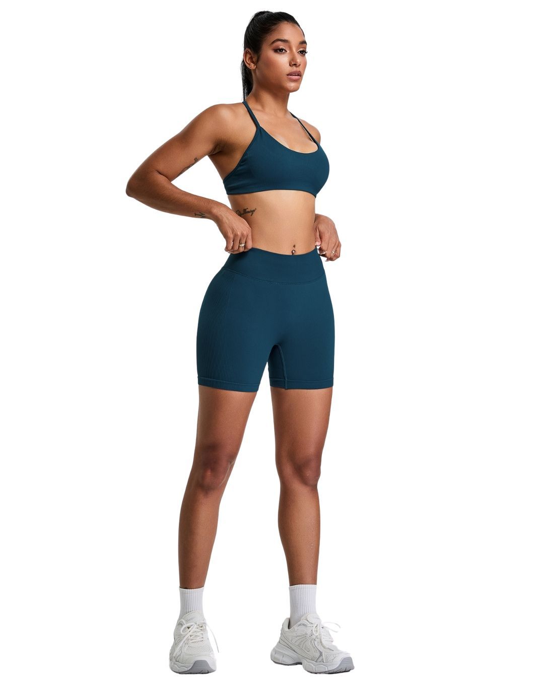 Woman wearing blue ORU Elura shorts with 4-way stretch, high-rise waistband, and gusseted crotch design for active wear
