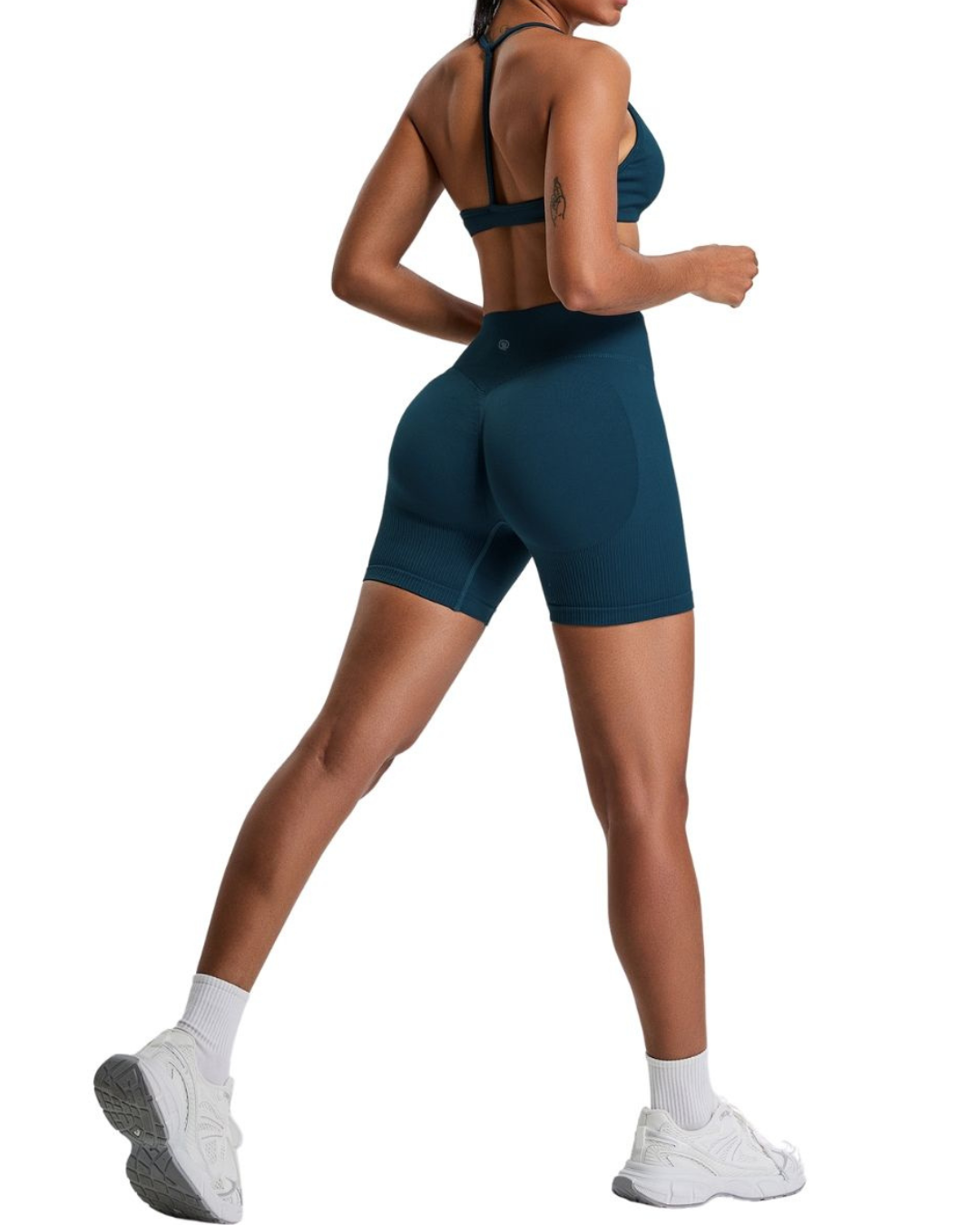 Woman in blue ORU Elura Shorts with 4-way stretch and high-rise waistband, shown from back in active pose
