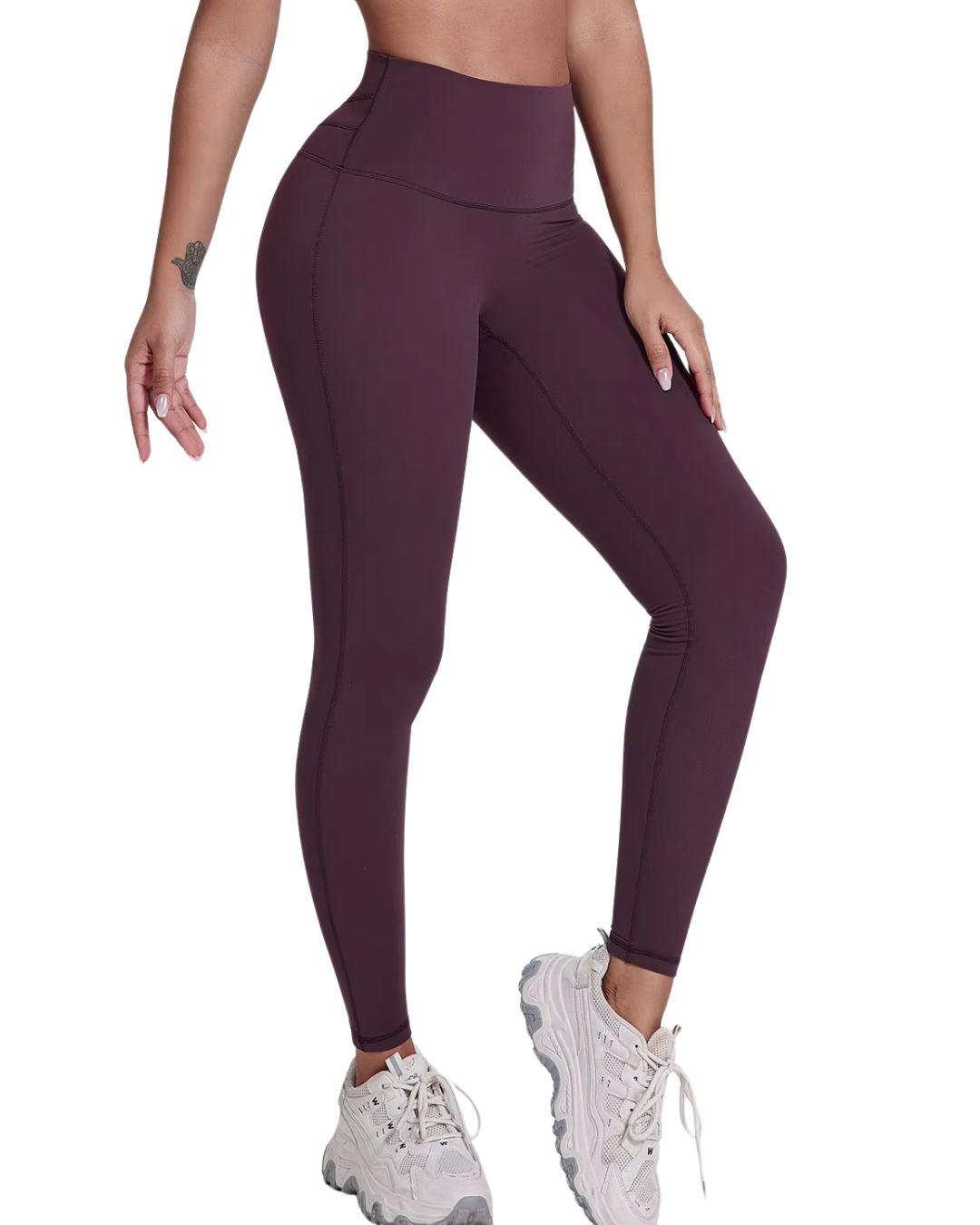Women wearing ultra high rise ORU Legacy Leggings in dark purple with butterfly 3-seam back waistband detail and white sneakers