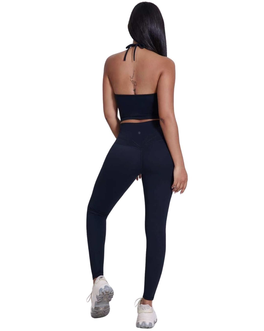 Woman wearing black ORU Legacy Leggings with ultra high rise and butterfly 3-seam back waistband detail