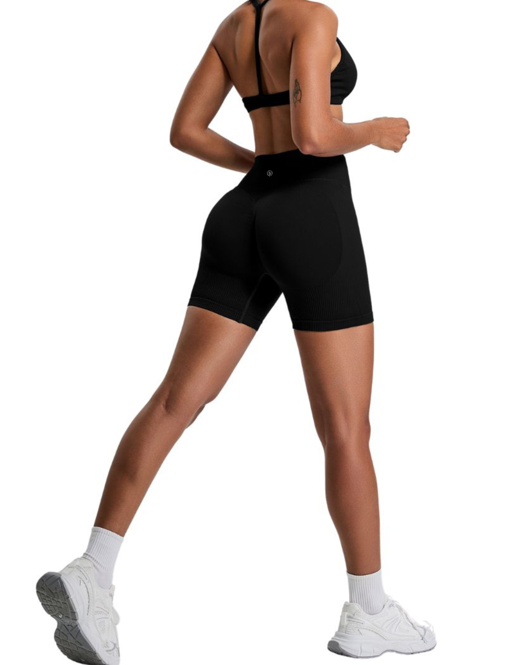 Woman wearing black ORU ELURA SHORT with 4-way stretch and high-rise waistband, shown from back in active pose.