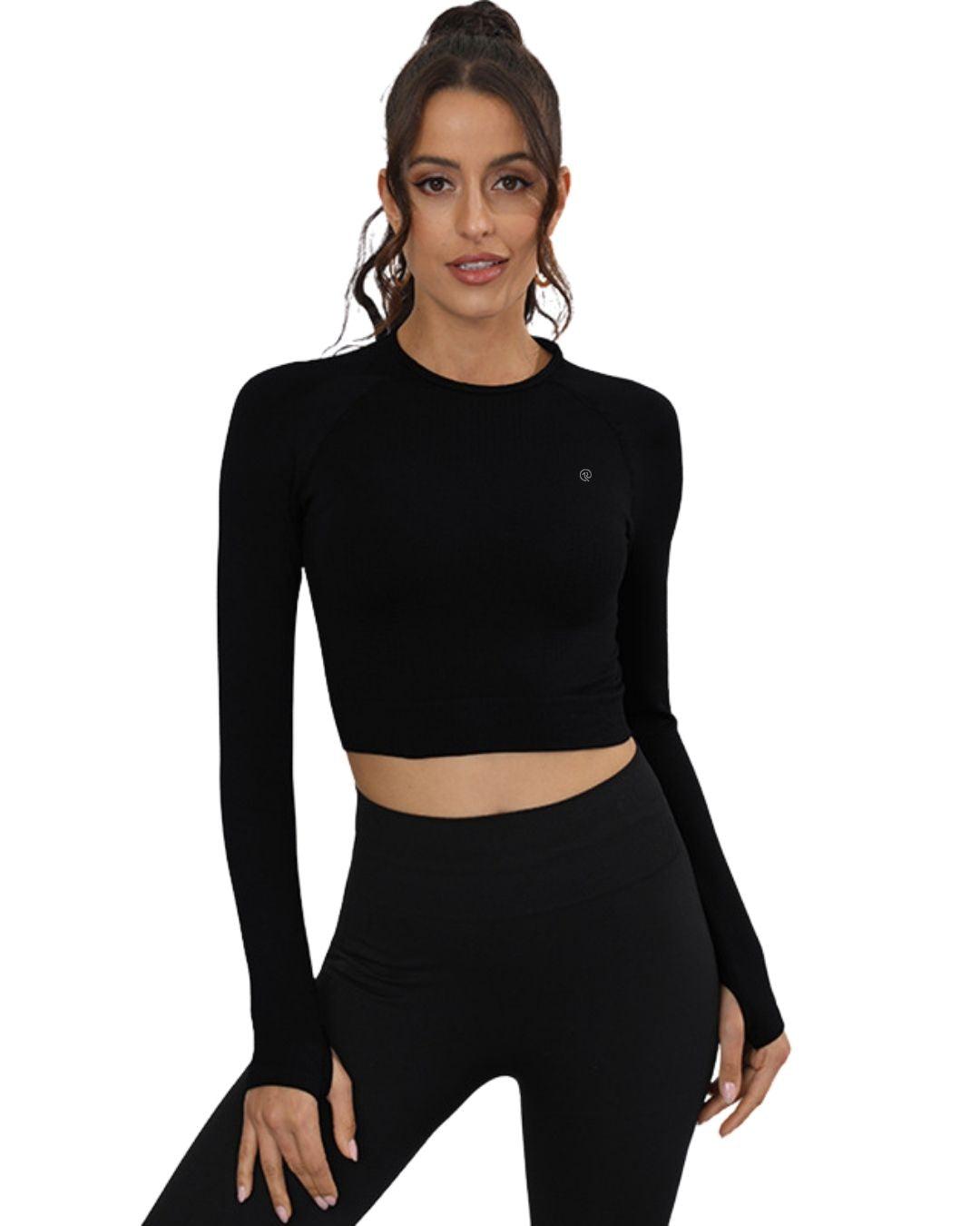 Woman wearing black ORU cropped long sleeve top with thumb hole cuffs and slim fit design for running and training