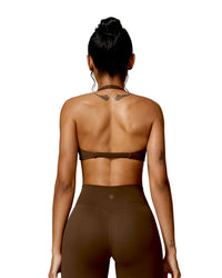 woman wearing brown oru mika halter sports bra with halter neck support and matching high-waisted leggings seen from back