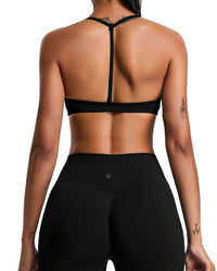 Back view of woman wearing black ORU Elura sports bra with T-shape strap and matching leggings