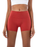Woman wearing red ORU Mid-Rise Yoga Shorts with slim fit and high stretch fabric