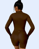 Woman wearing brown ORU MIKA Jacket with V-Shaped Back Design, breathable and quick-dry fabric for gym and yoga