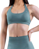 Woman wearing a teal Impact Sports Bra showing medium support and durable fabric.