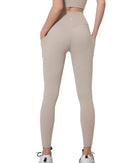 Beige ORU COZY POCKET LEGGINGS with high waist, side pockets, and firm compression for hip shaping and comfort.