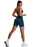 Athletic woman wearing ORU Elura sports bra with T-shape back and matching shorts