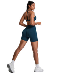 Athletic woman wearing ORU Elura sports bra with T-shape back and matching shorts