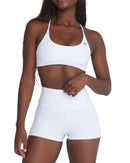 Woman wearing white ORU CROSSOVER SPORTS BRA with seamless design and strappy back