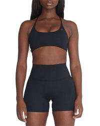 woman wearing black ORU CROSSOVER SPORTS BRA with seamless design and strappy back