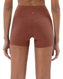 Back view of ORU Mid-Rise Yoga Shorts in brown with high stretch and subtle glute contour design